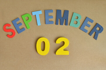September 2, Toy alphabet with a brown background.