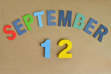 September 12, Toy alphabet with a brown background.