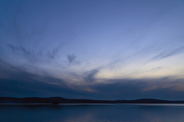 beautiful clouds during blue hour over the lake