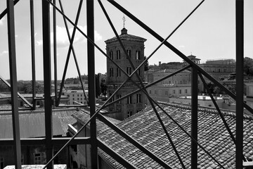 Bell tower of the church Santo Spirito in Saxia in Rome. View from the rooftops. Black and white photo.