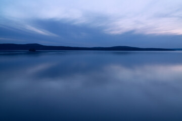 Fototapeta premium beautiful clouds during blue hour over the lake