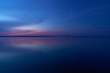 Fototapeta na wymiar beautiful clouds during blue hour over the lake