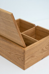 Large wooden box with a separator on a light mint background empty. Product Display Concept. Copy space. Oak box on the table, closeup details. Vertical photo