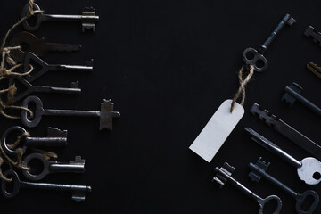 Set of vintage keys for a lock. Retro keys on a dark stone background. The concept of choosing the...