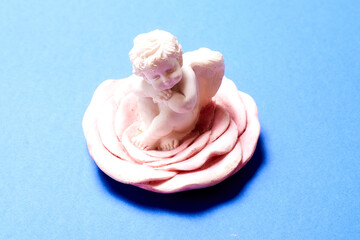 gypsum angel figurine on a blue background.