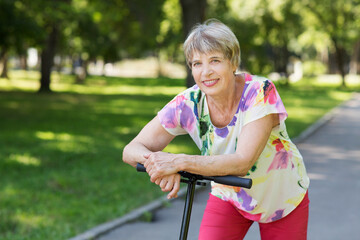 senior woman riding a scooter in the park. Active Seniors