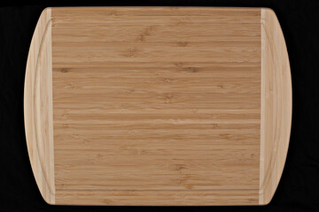 Wooden cutting board on a black background