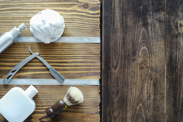Shaving accessories on a wooden texture background. Tools. Disposable shaving machine, brush, foam and hazard razor.