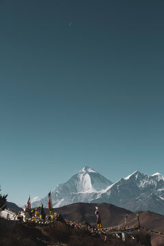 praying flags near muktinath temple at mustang, Nepal. Deep blue sky sunny day and everest mountain on the background.