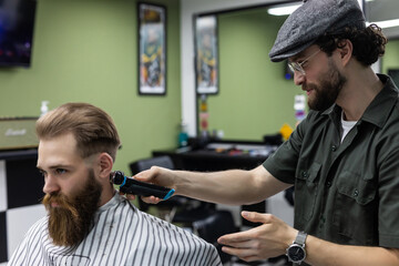 Haircut men Barbershop. Men's Hairdressers barbers. Barber cuts the client machine for haircuts.