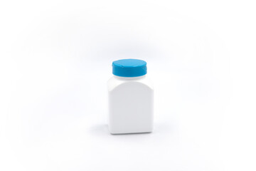 White plastic bottle for pills or food supplement studio photo on white background. Pharmacologic container mockup. Pill or drug jar blank package design. Medical bottle isolated with shadow