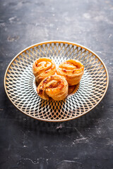 Fresh sweet bun with orange jam on the rustic wooden background. Selective focus. 