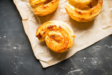 Fresh sweet bun with orange jam on the rustic wooden background. Selective focus. 
