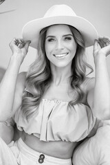 Portrait of smiling woman in fashionable hat.