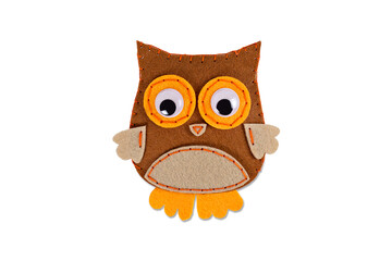 Needlework. Sewing toy with colored thread. Handmade soft toy. Needle, texture. Toy owl on a white background