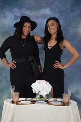 Two happy black women at a romantic table for two