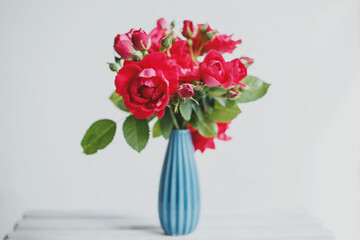 Bouquet of red roses in a blue vase
