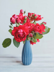 Bouquet of red roses in a blue vase