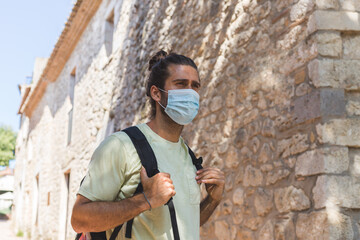 Obraz na płótnie Canvas a young man wearing a mask outdoors