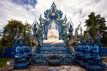 Wat Rong Suea Ten or The Blue Temple translates as House of the dancing tiger. A monumental, modern Buddhist temple distinguished by its vivid blue coloring & elaborate carvings in Chiang Rai Province