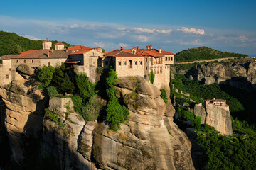 Fototapeta na wymiar Monastery of Varlaam monastery and Monastery of Rousanou in famous greek tourist destination Meteora in Greece on sunset with scenic scenery landscape