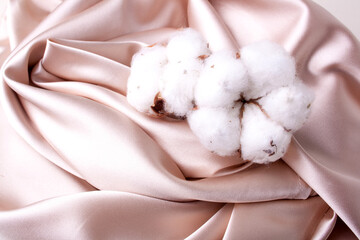 Satin peach fabric and cotton background