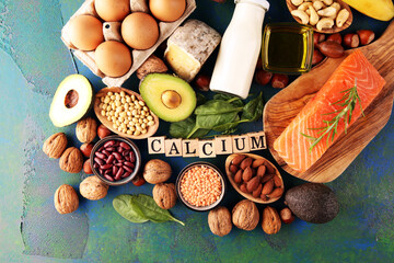 Best Calcium Rich Foods Sources. Healthy eating. Foods rich in calcium such as bean, almonds, hazelnuts, spinach leaves, cheese, and fresh milk - obrazy, fototapety, plakaty