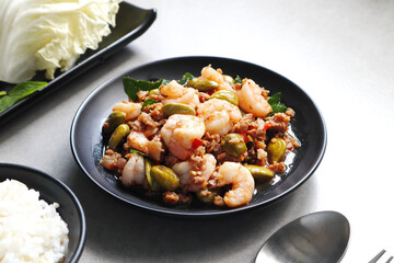 stir fried bitter bean with shrimp (sator in Thai) set with rice and white radish and basil