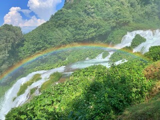 Beautiful rainbow on waterfall in Italy