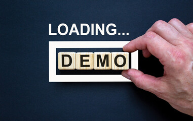 Loading word 'demo' with hand putting wood cube in progress bar. Business concept.
