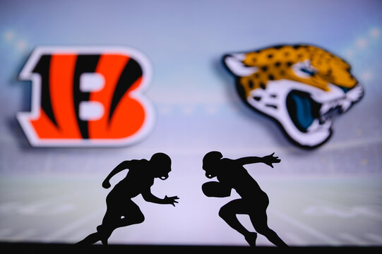 Cincinnati Bengals vs. Jacksonville Jaguars. NFL match poster. Two american football players silhouette facing each other on the field. Clubs logo in background. Rivalry concept photo.