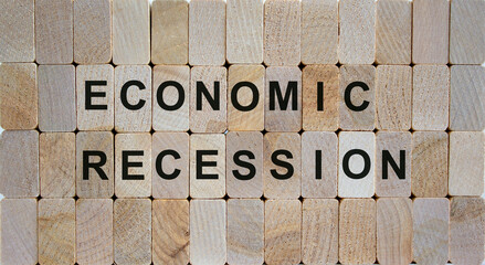 Wooden blocks form the words 'economic recovery'. Beautiful wooden background. Business concept.
