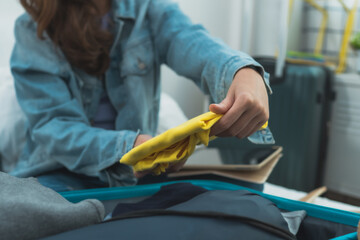 Close up hand fold cloth into backpack, ready to travel and journey