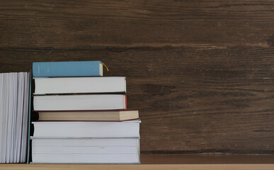 Stack of books on the school desk, space for text