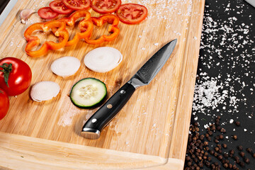 Closeup of hands of chef cook cutting vegetables on wooden table