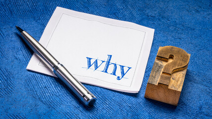 why question on a napkin with vintage letterpress wood type question mark against against blue bark...