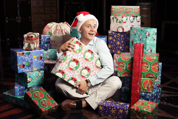 man in  Santa hat near a lot of gifts boxes