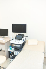ultrasound room with modern equipment and a couch