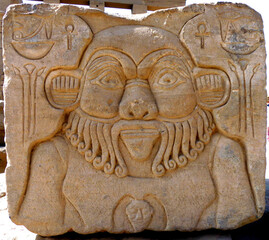 Temple carving of the ancient Egyptian god Bes on Philae Island, Egypt