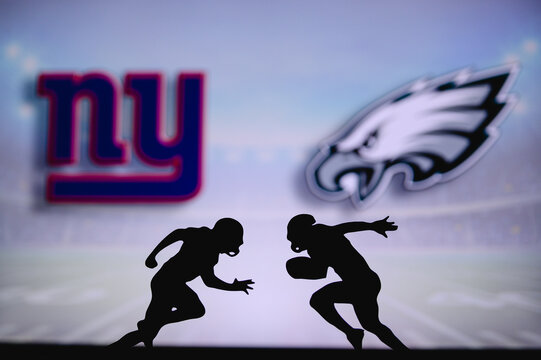 New York Giants Vs. Philadelphia Eagles. NFL Match Poster. Two American Football Players Silhouette Facing Each Other On The Field. Clubs Logo In Background. Rivalry Concept Photo.