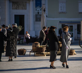 Two female models dressed like 50s in a square