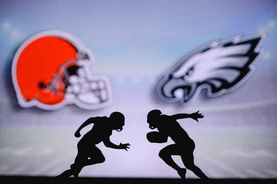 Cleveland Browns vs. Philadelphia Eagles. NFL match poster. Two american football players silhouette facing each other on the field. Clubs logo in background. Rivalry concept photo.