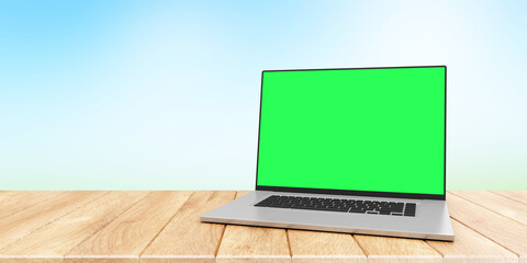 Modern laptop with green screen on wooden table