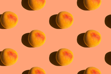 Seamless pattern from ripe juicy yellow red peaches on pink background. Creative food poster banner template backdrop for wallpaper product surface design summer theme