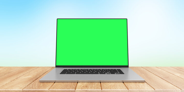 Modern laptop with green screen on wooden table