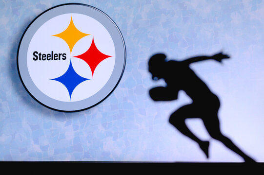Pittsburgh Steelers. Silhouette of professional american football player. Logo of NFL club in background, edit space.