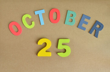 October 25, Toy alphabet with a brown background.