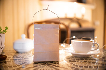 Coffee pouch mockup with coffee cup and milk on dark romantic background. Paper clear bag in...