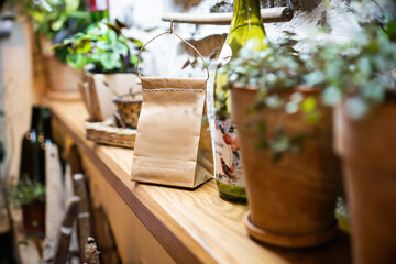 Coffee pouch mockup with coffee cup and milk on dark romantic background. Paper clear bag in candles light