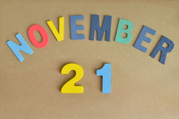 November 21, Toy alphabet with a brown background.